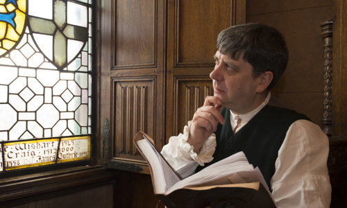 A re-enactor dressed as poet Robert Burns in the great hall at Edinburgh Castle.