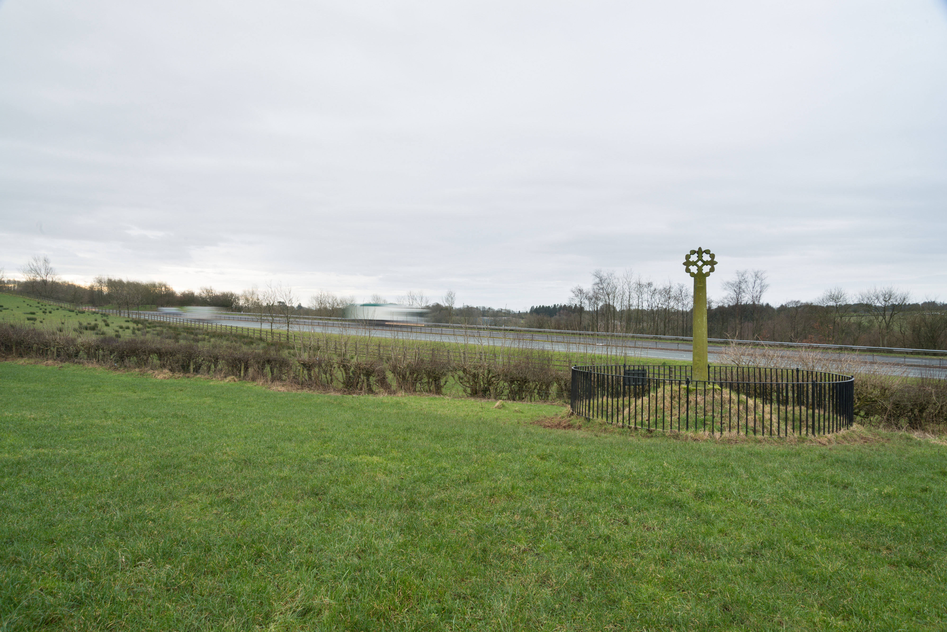 A small stone cross on the side of a road