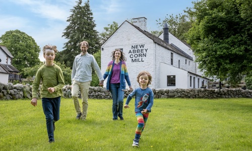 A family enjoy a day out at New Abbey Corn Mill. 