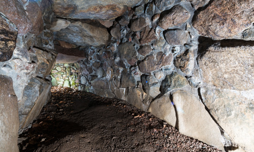 A narrow underground passage made from stones