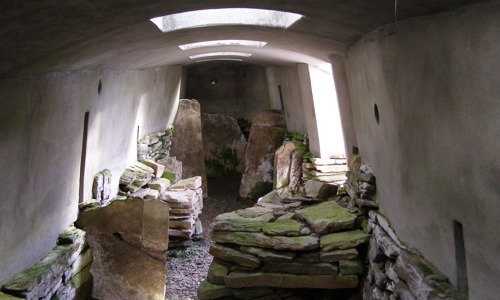 Several slabs of stone being stored in a concrete room