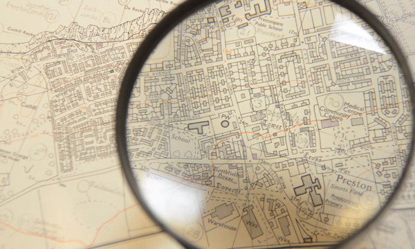 A magnifying glass held over an ordnance survey map of Prestonpans in East Lothian.