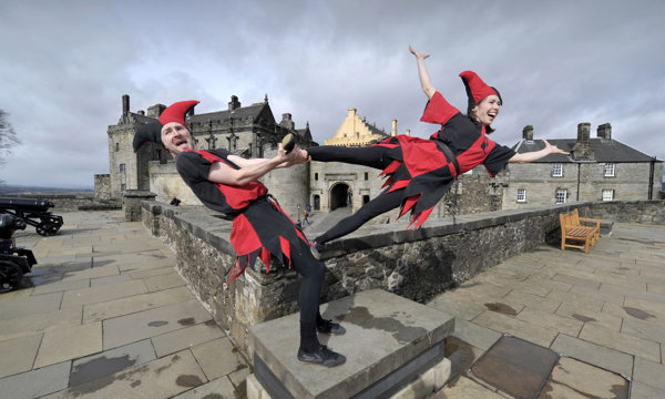 Two jesters play in front of Stirling Castle.