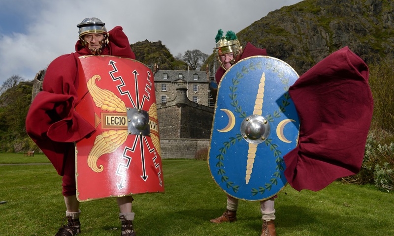 Two roman centurions on the grass in front of Dumbarton Castle