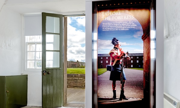 Reception area at Fort George with tall banner headed "Explore the Fortress"