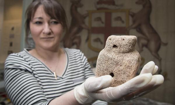 Curator holding an artifact