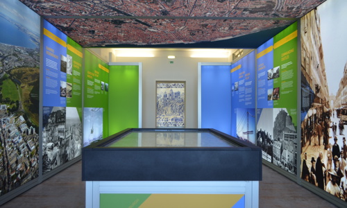 An exhibition with maps and text on the walls and ceiling