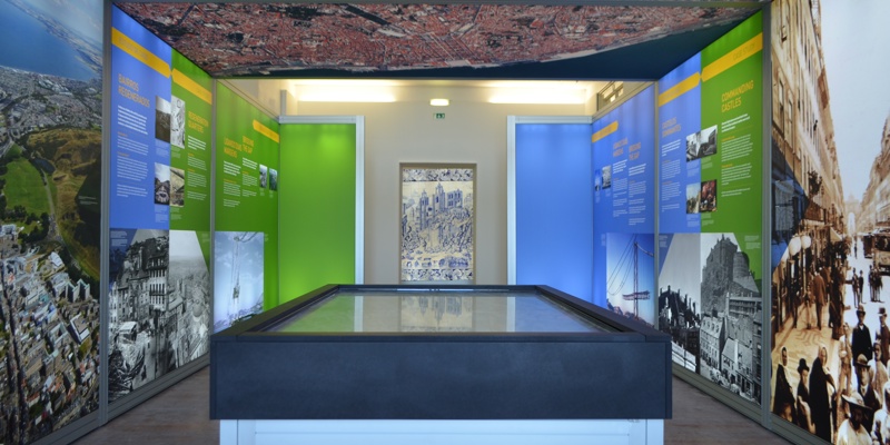 An exhibition with maps and text on the walls and ceiling