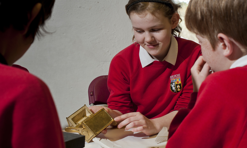 School pupils handling a replica reliquary