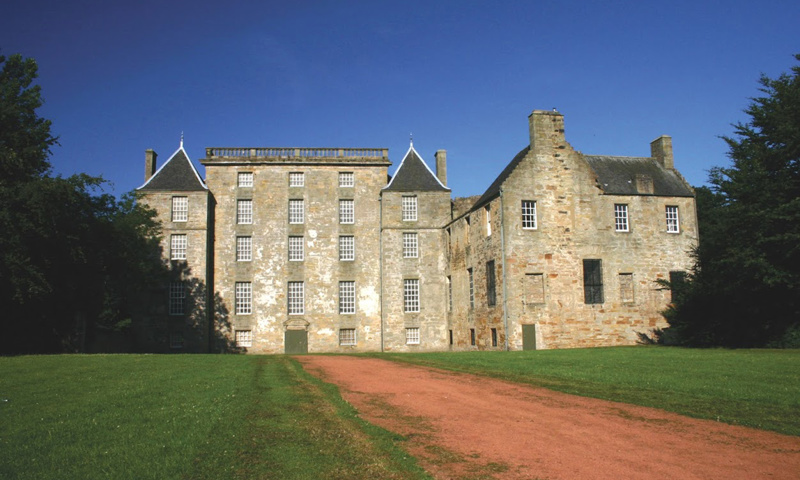 General view of Kinneil House from the driveway, with trees visible at either side of the house