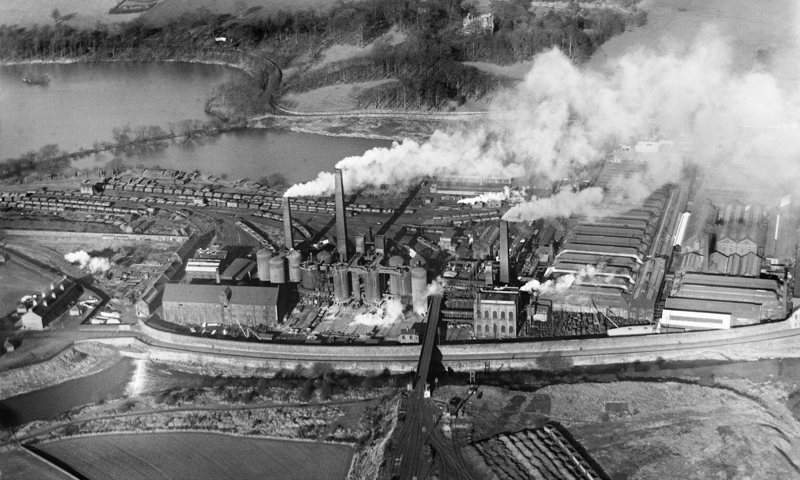 Black and white aerial photo of Carron Co Iron Works with smoke coming out of the chimneys