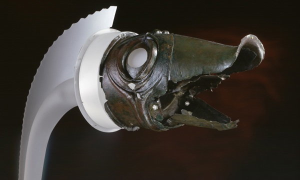 Head of a Carnyx with dark red background