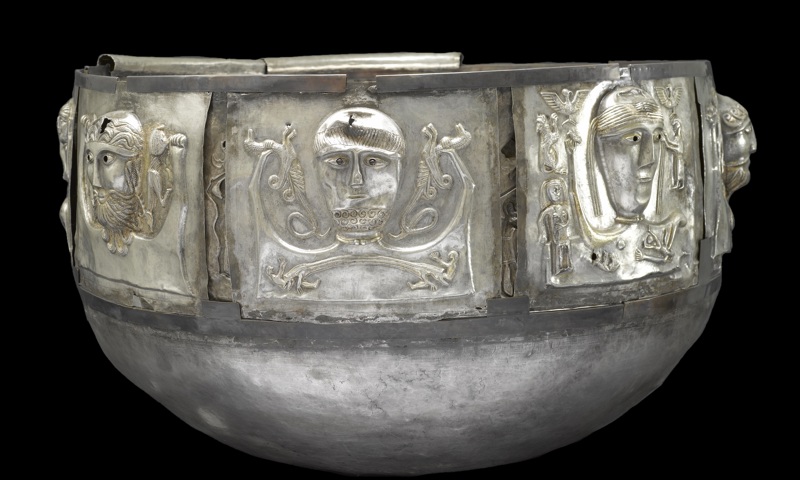 Silver historical artifact with plain black background
