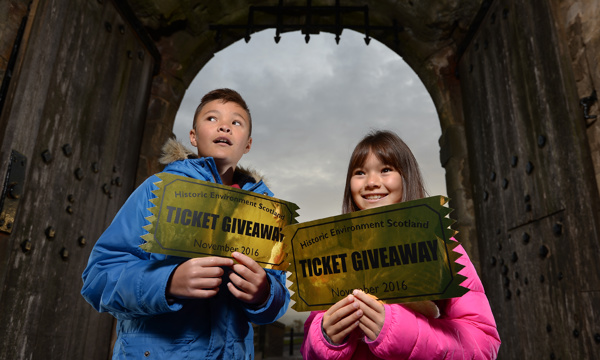 Two children holding golden tickets from the Ticket Giveaway promotion