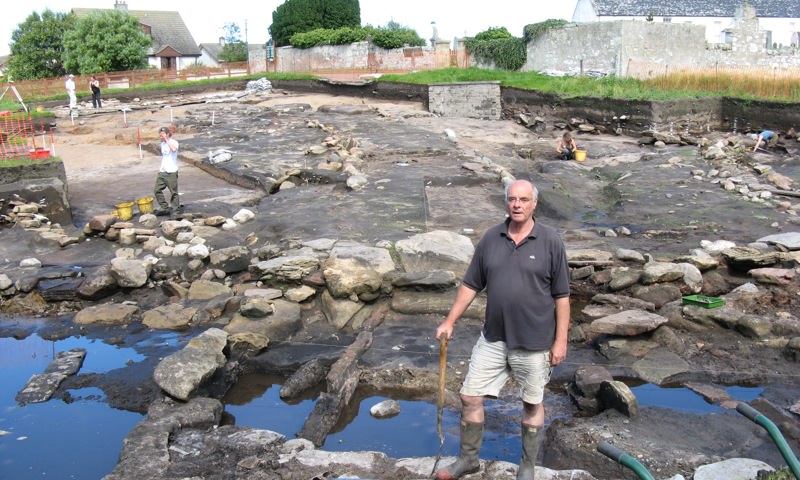A man with a spade standing at Tarbat Ness excavation site