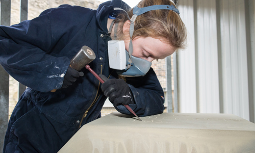 Apprentice stonemason, Megan Crawford, carving words on the the plinth stone for the Mary Queen of Scots statue that is to be erected at Linlithgow Palace