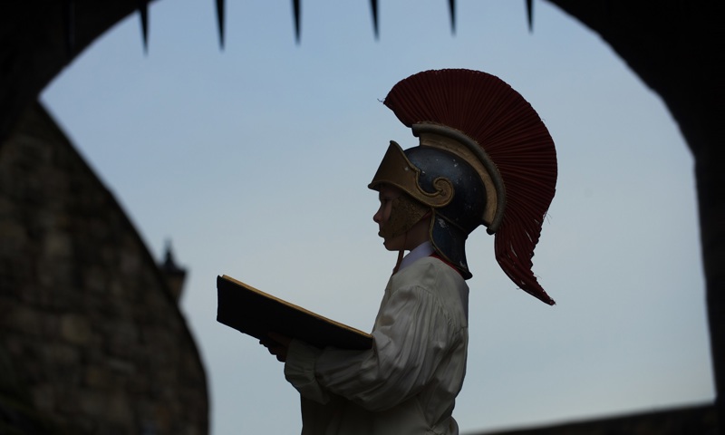 Side view of a child at Edinburgh castle wearing a roman centurian