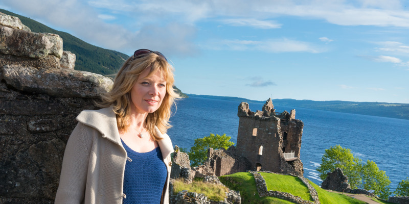 Visitor at Urquhart Castle with the loch behind her