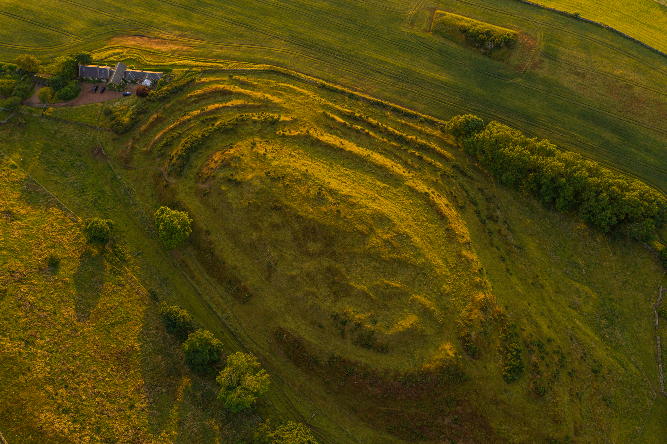 Aerial view of Chesters Hill Fort in the sunlight