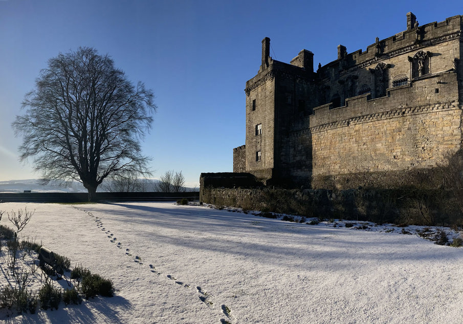 Blue skies and winter sunshine over Stirling Castle's Queen Anne Garden with snow on the ground glistening in the sun
