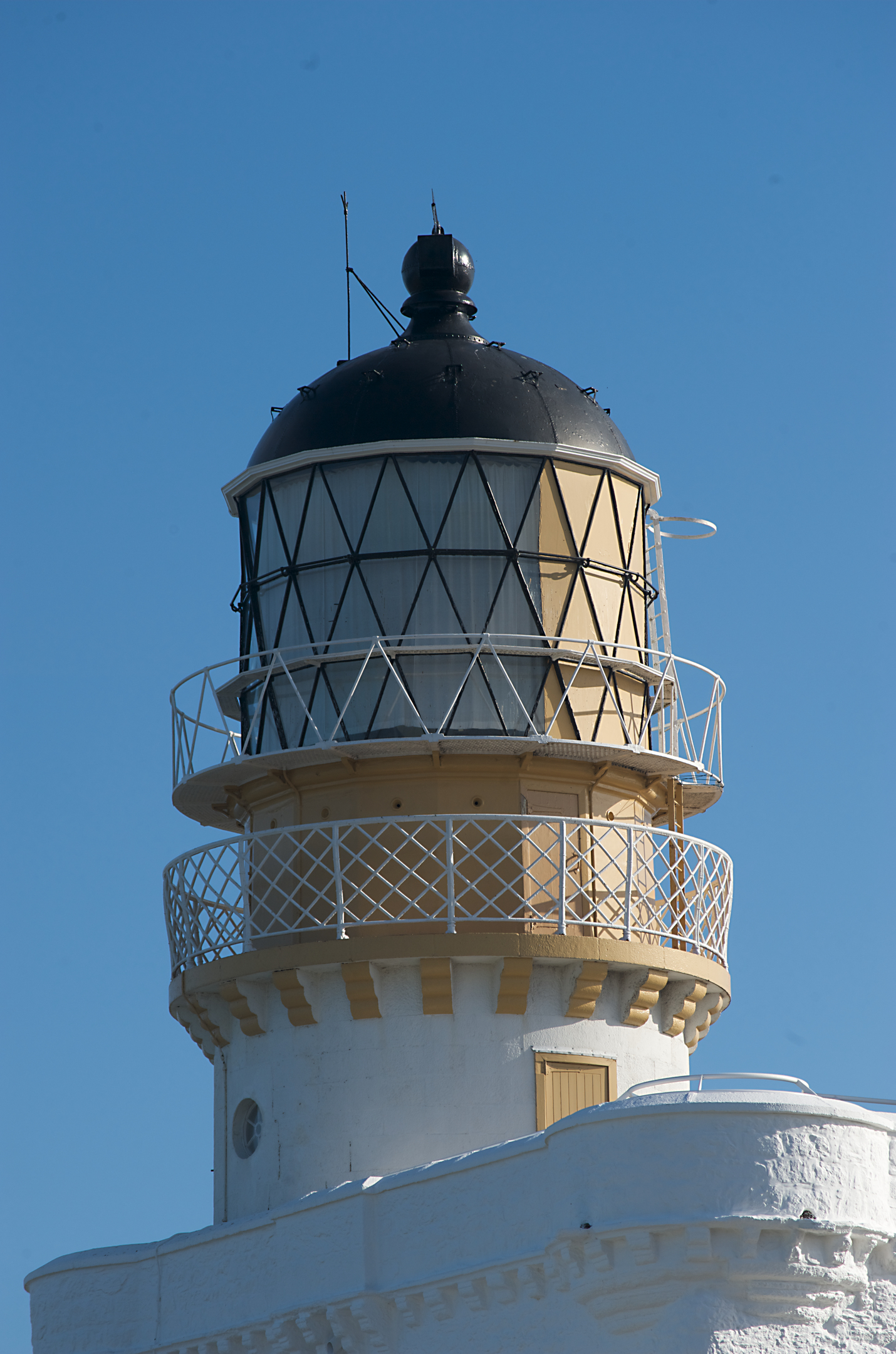 A close-up of the large circular light on top of Kinnaird Head Lighthouse. 
