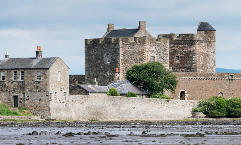 A photograph of a castle by the water.