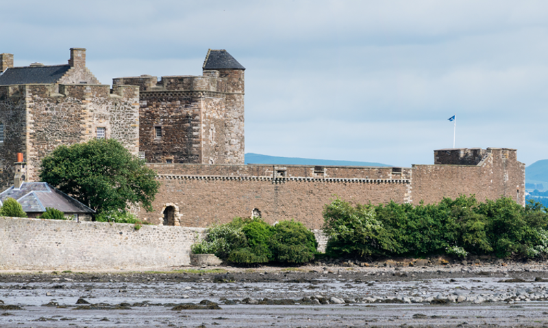 A photograph of a castle by the water.