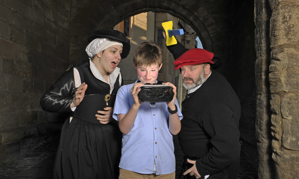 Costumed performers with a visitor at Stirling Castle