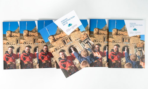 The HES Annual Operating Plan 2017-18 displayed in a fanned arrangement, with one on top in the centre at an angle