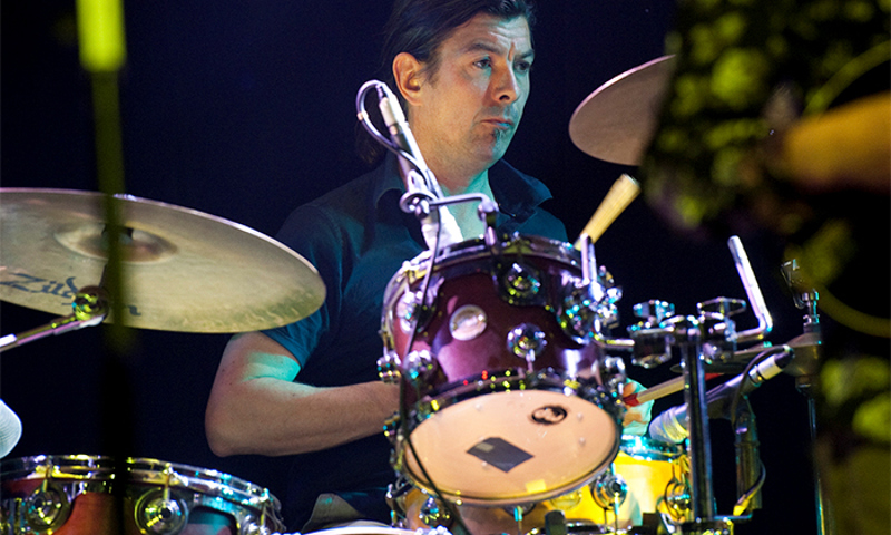 Shooglenifty drummer on stage playing drums