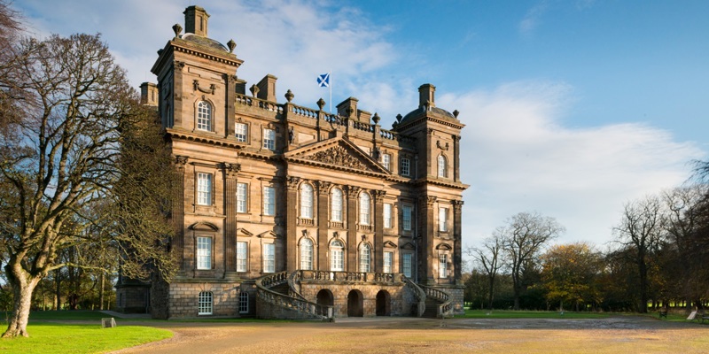 A photograph of a country house in the sunshine