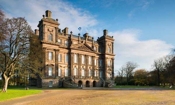 A photograph of a country house in the sunshine