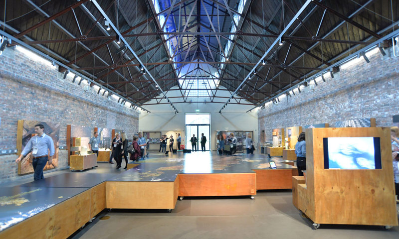 Photograph of the interior of a modern building with exhibitions set up