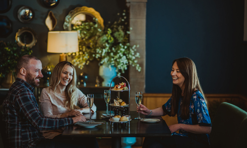 Three people at a table at Edinburgh Castle Tea Room
