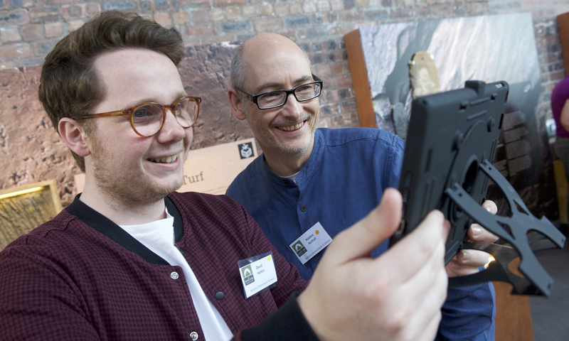 Two people on a tablet device at The Engine Shed