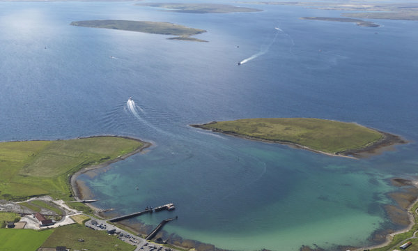 a bay of blue water with green land curving around it