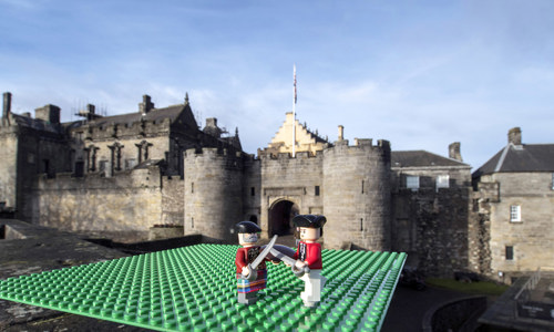 lego soldiers duel with a castle in the background