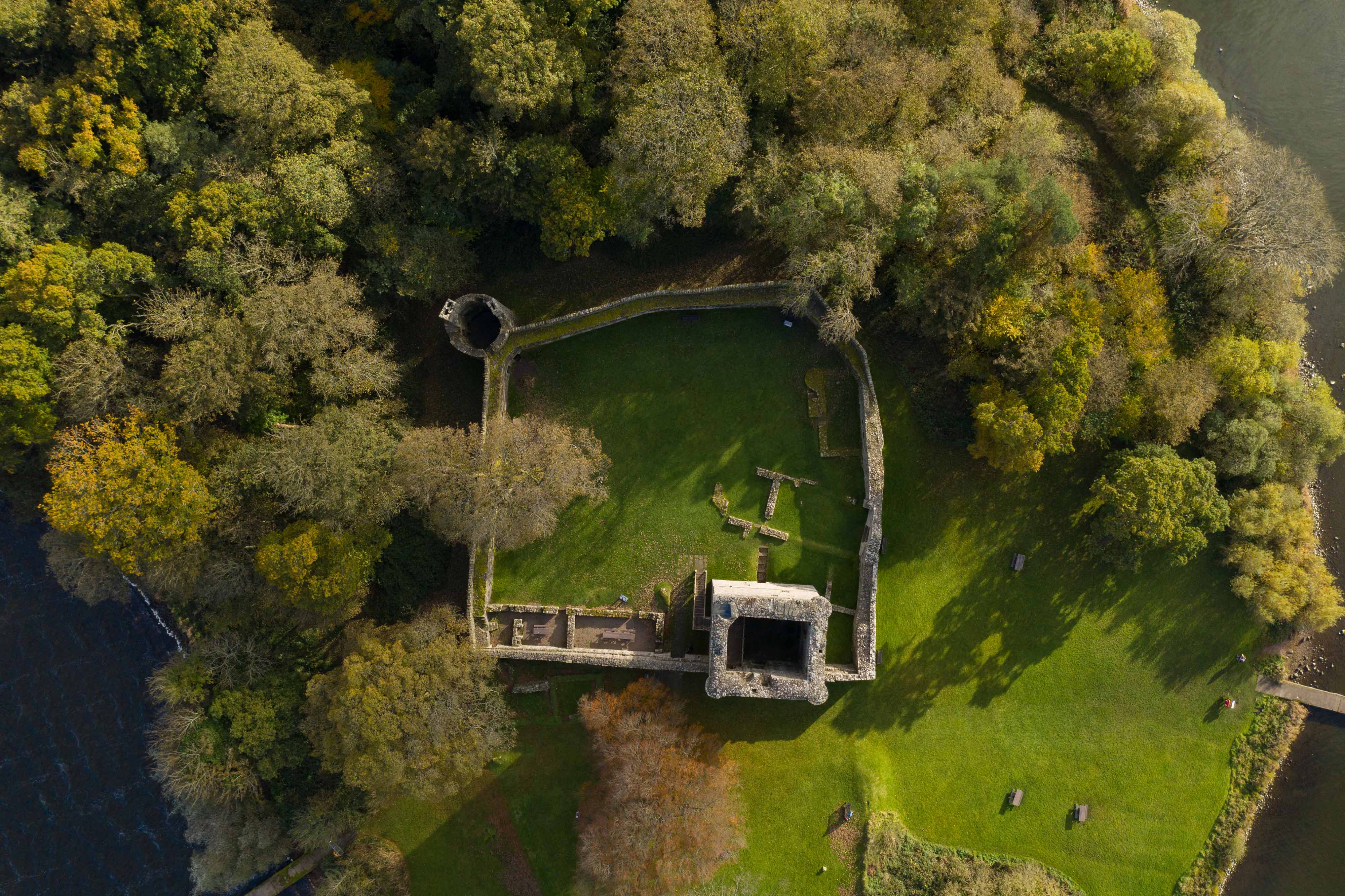 A square castle complex, with high walls and a stone tower, from above