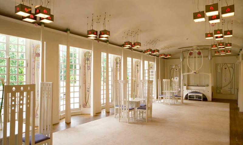 A photograph of a room with unusual chairs and light shades