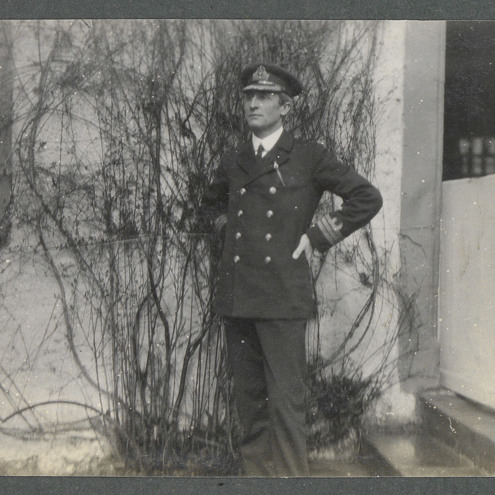 Black and white photo of man wearing an officer