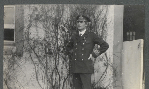 Black and white photo of man wearing an officer