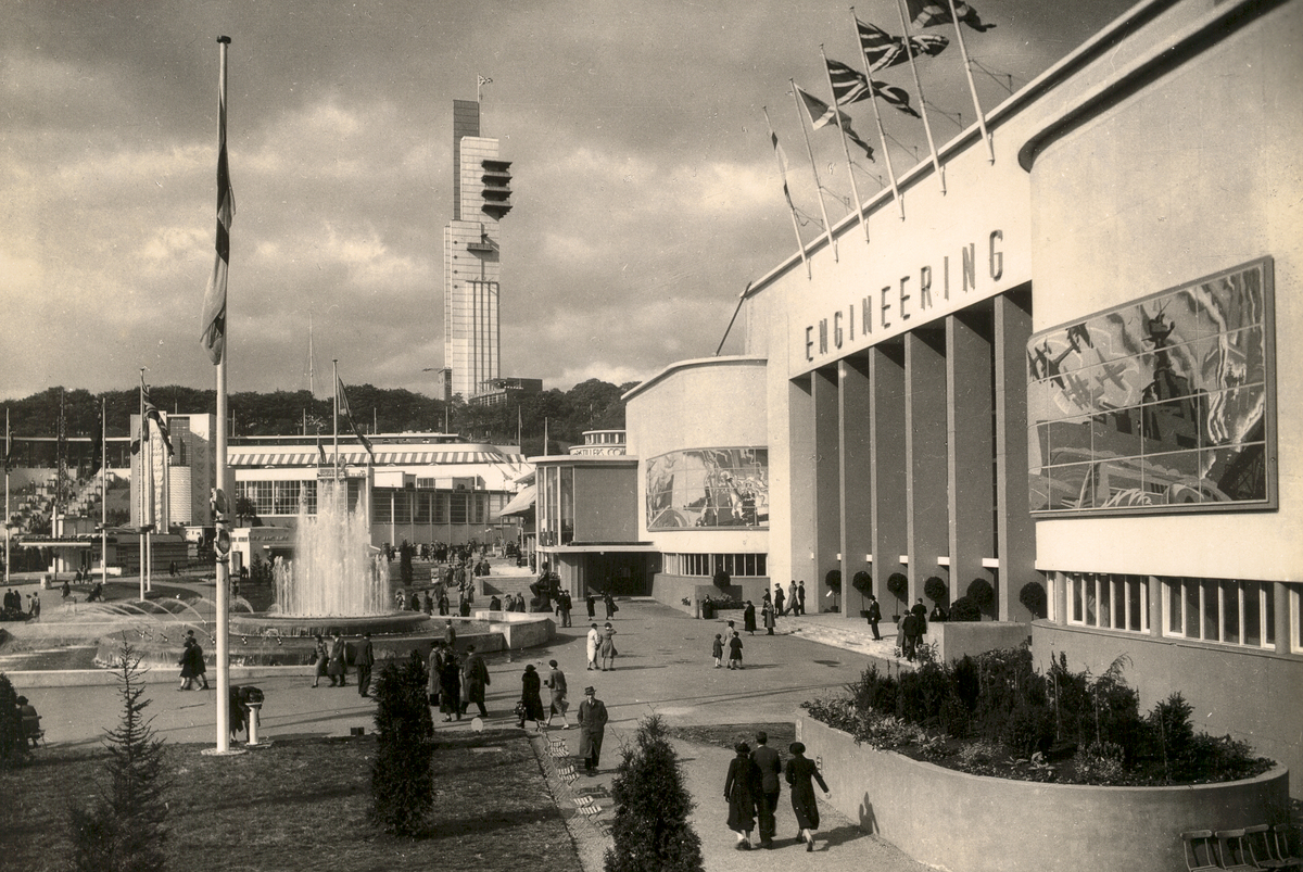 Black and white photograph of the Empire Exhibition in Glasgow, showing a buidling with ENGINEERING sign and a tower in the distance