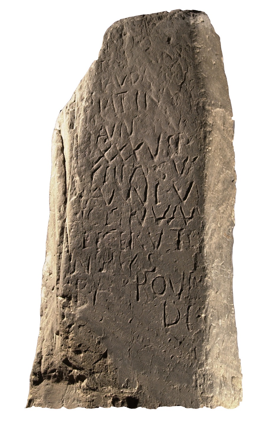 Photograph of the Latinus Stone, a rough‑edged pillar with early Latin Christian inscriptions carved vertically into its surface.