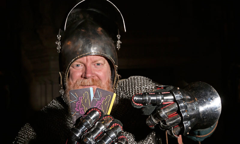 A knight holding tickets to event