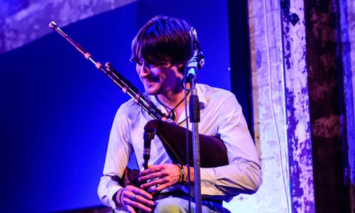 Gaelic musician, Ross Ainslie plays the bagpipes on stage