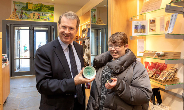 Alex Patterson stands with a winner for the Urquhart Castle Shop competition