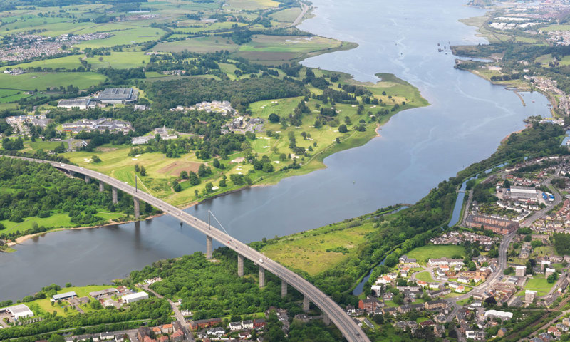 An aerial view of a large road bridge over a river.