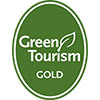 A graphic of a green circle with the words "Green Tourism gold award"