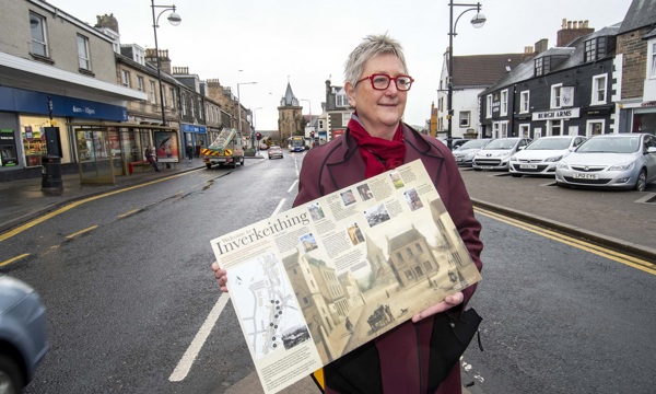Jane Ryder OBE posing with an interpretation panel in Inverkeithing 