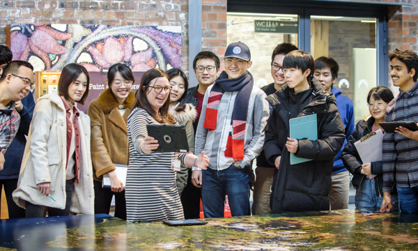Students enjoy an iPad presentation with a member of staff at the engine shed.